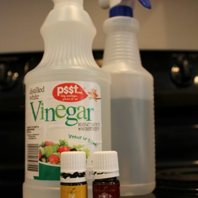 spray bottles of homemade cleaner with essential oils