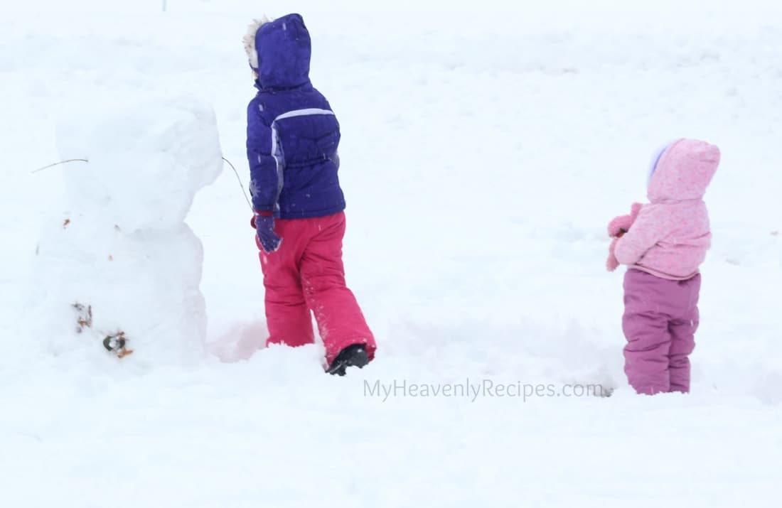 two kids playing in the snow