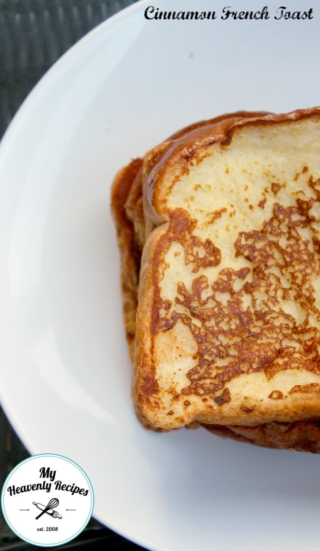 Shot of cinnamon french toast plated on a white plate featuring the crust on the bread