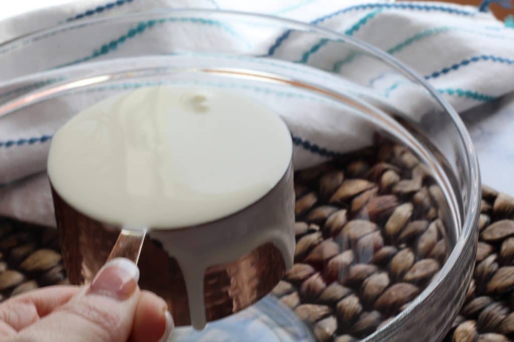 heavy whipping cream in measuring cup