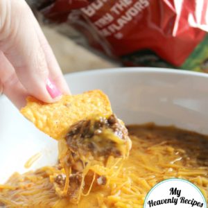 Doritos scooping up Skyline chili dip from a bowl