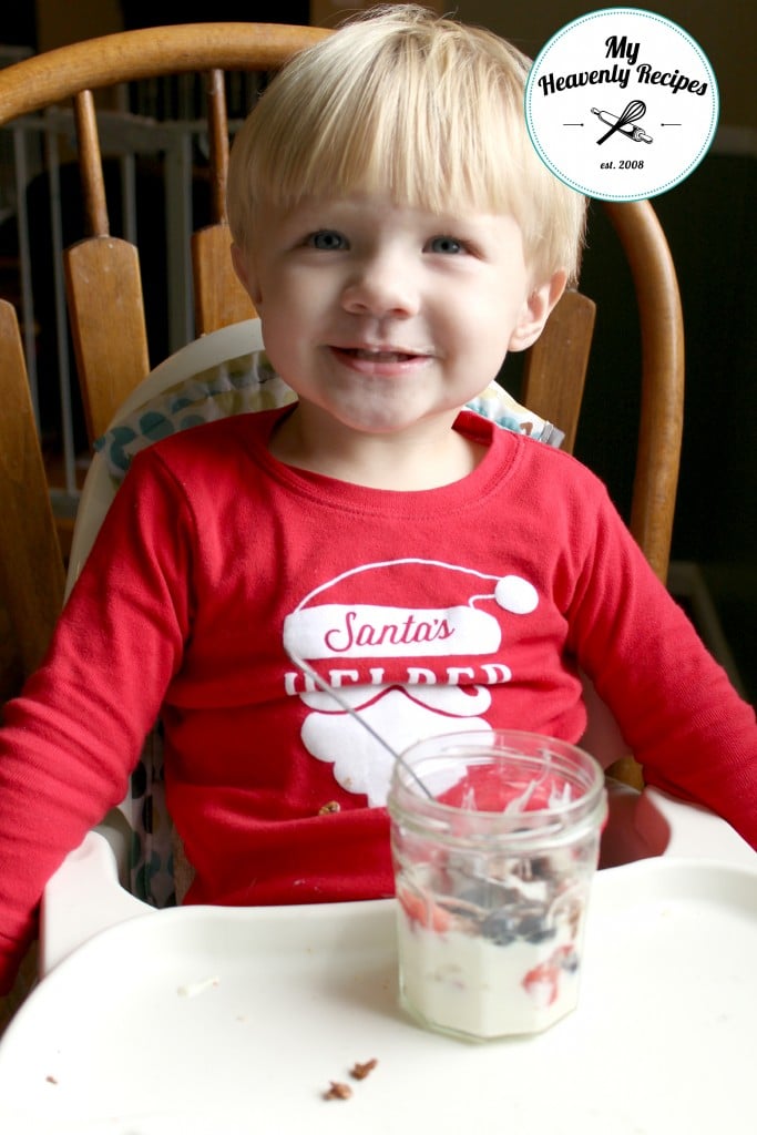 toddler eating a yogurt and fruit parfait
