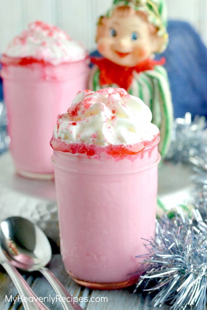 strawberry hot chocolate topped with whipped cream, served in a mason jar glass