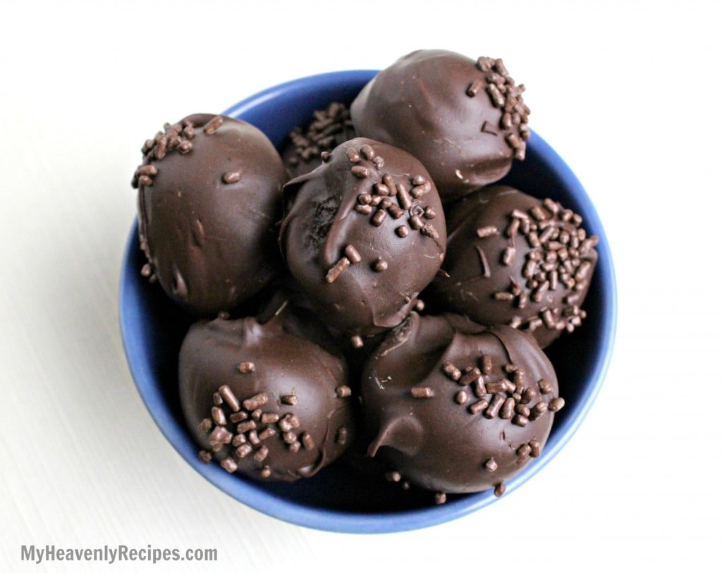 chocolate truffles with chocolate sprinkles in a blue bowl set on a white table