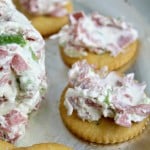 cheese ball dip served on crackers on a silver platter