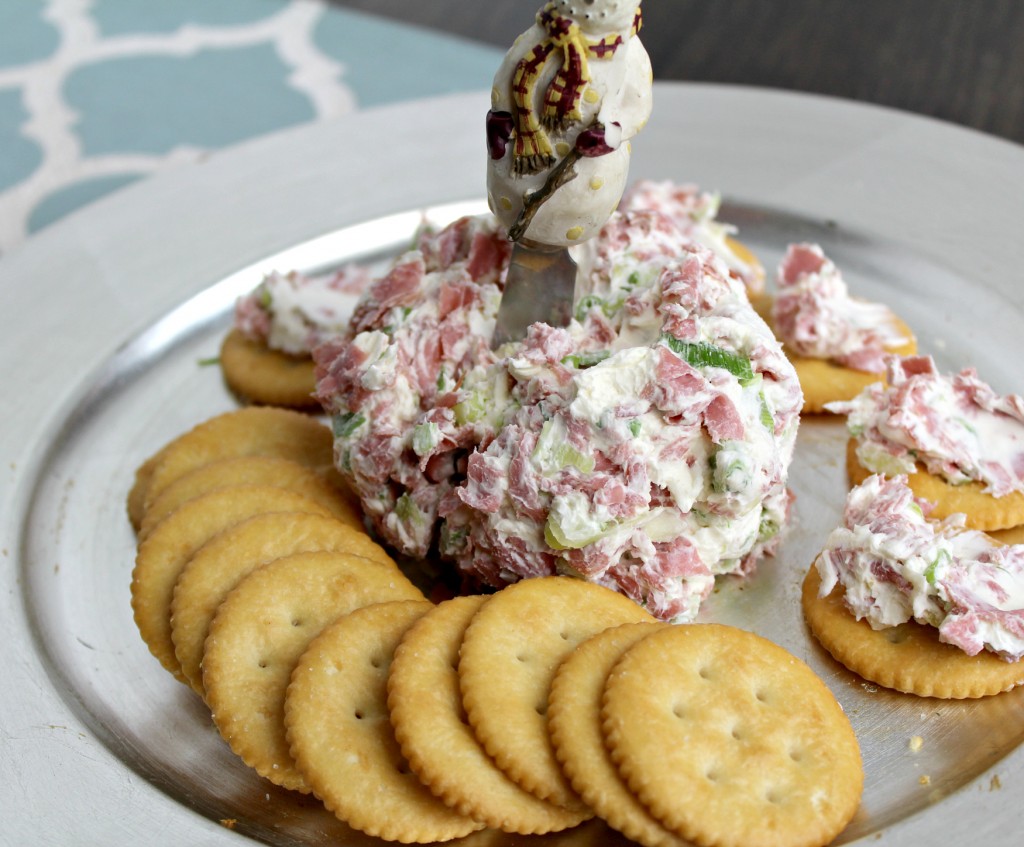 cheese ball dip appetizer on a plate with buttery crackers