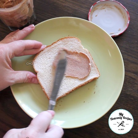 spreading cinnamon butter on a slice of bread