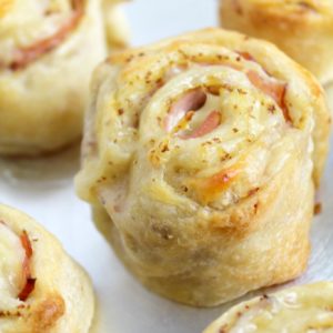 ham and cheese roll ups on a white plate