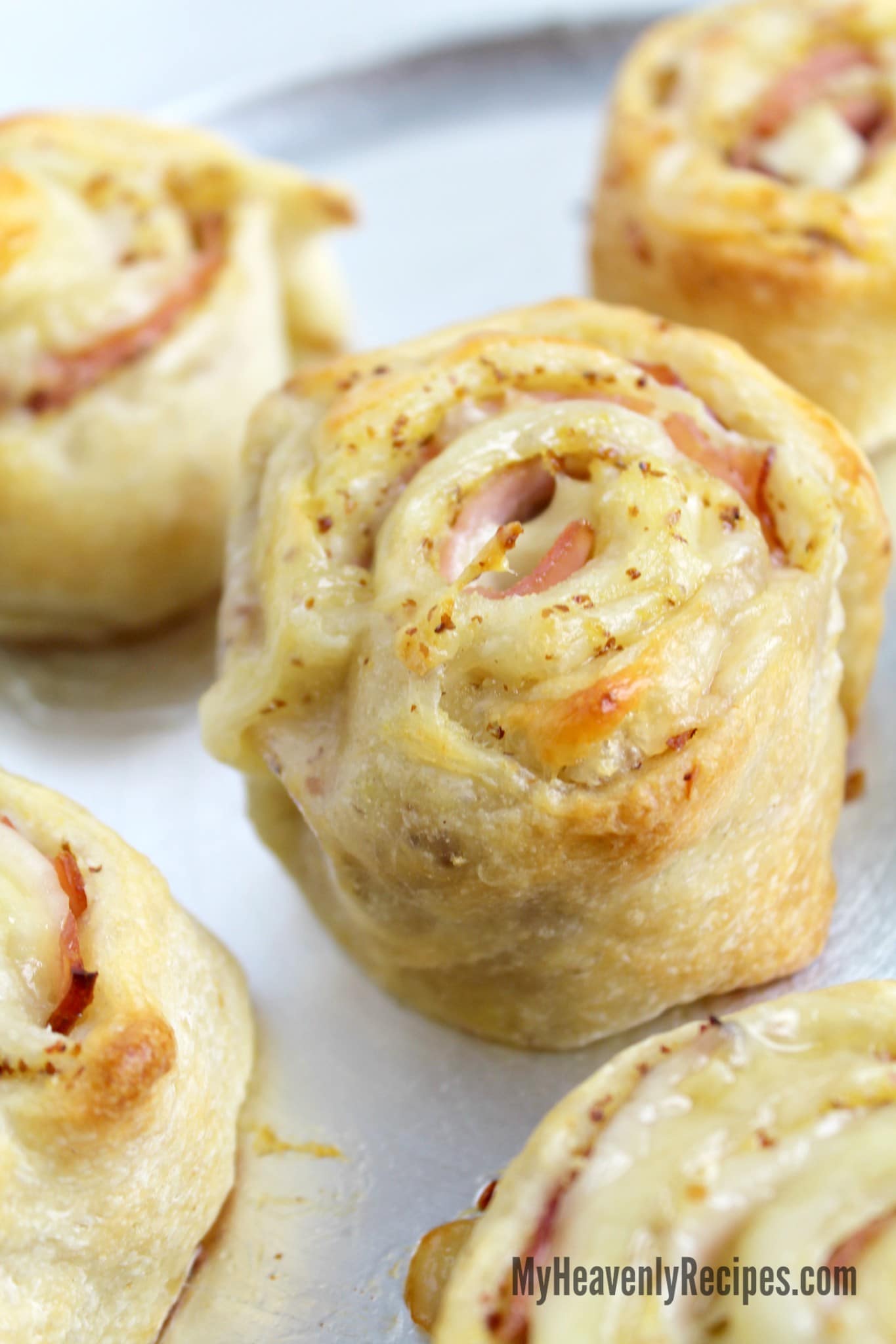 ham and cheese roll ups on a white plate