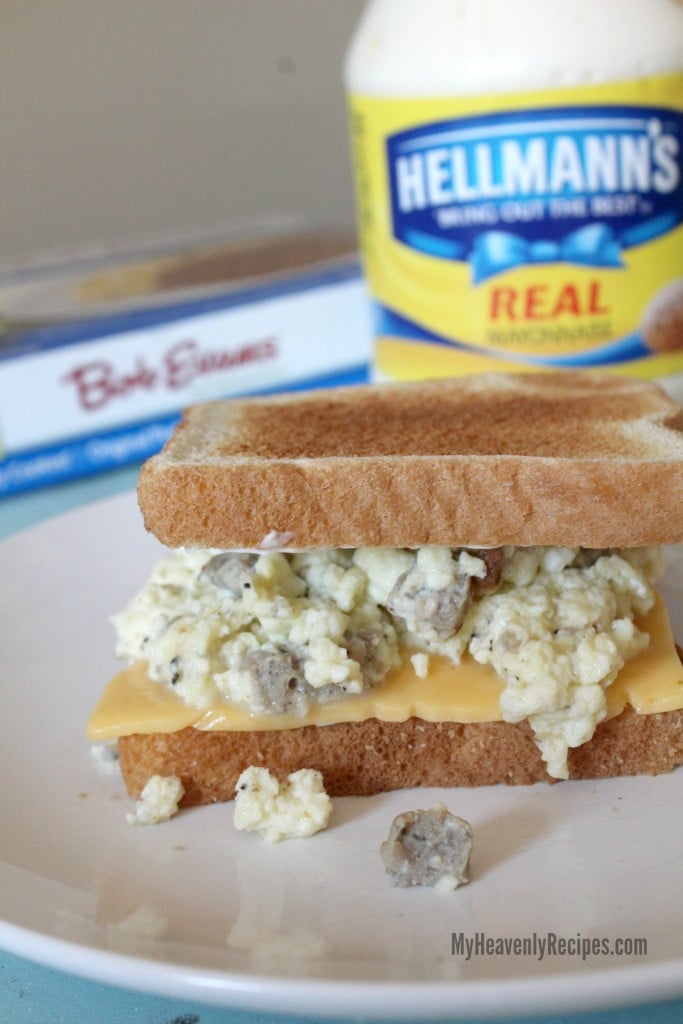 sausage egg and cheese sandwich on a white plate with bob evans sausage and mayo in background