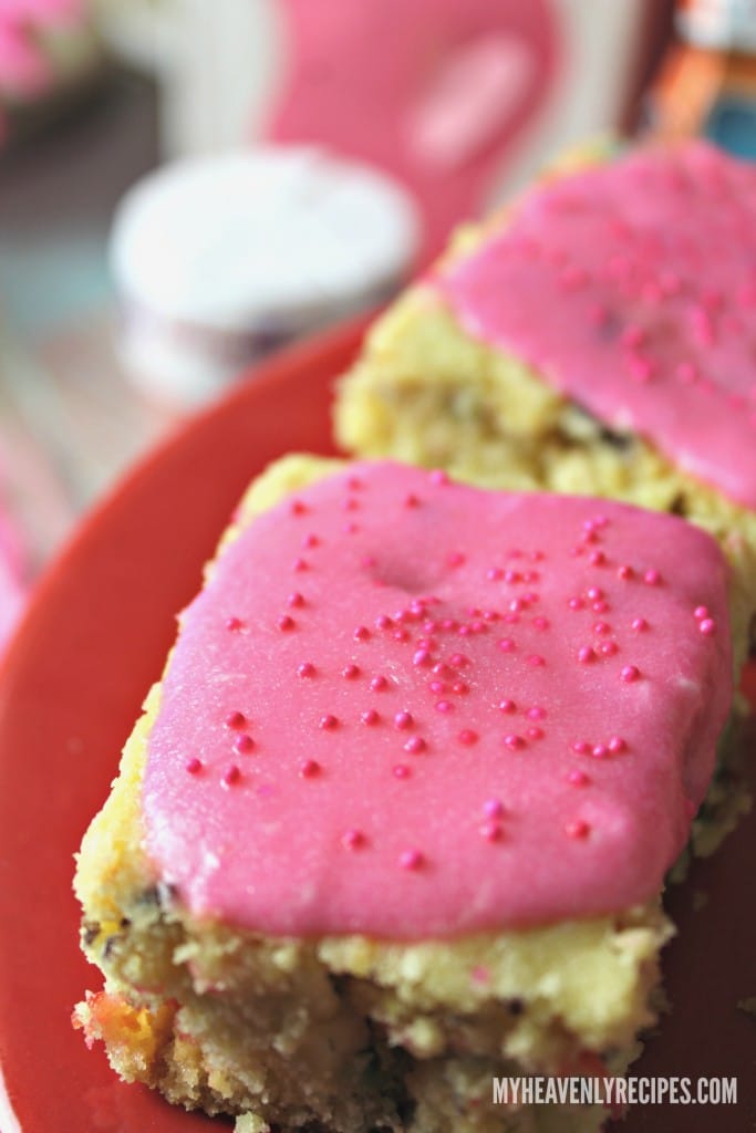 unicorn dessert - chocolate chip cookie bars with colored sprinkles and pink frosting