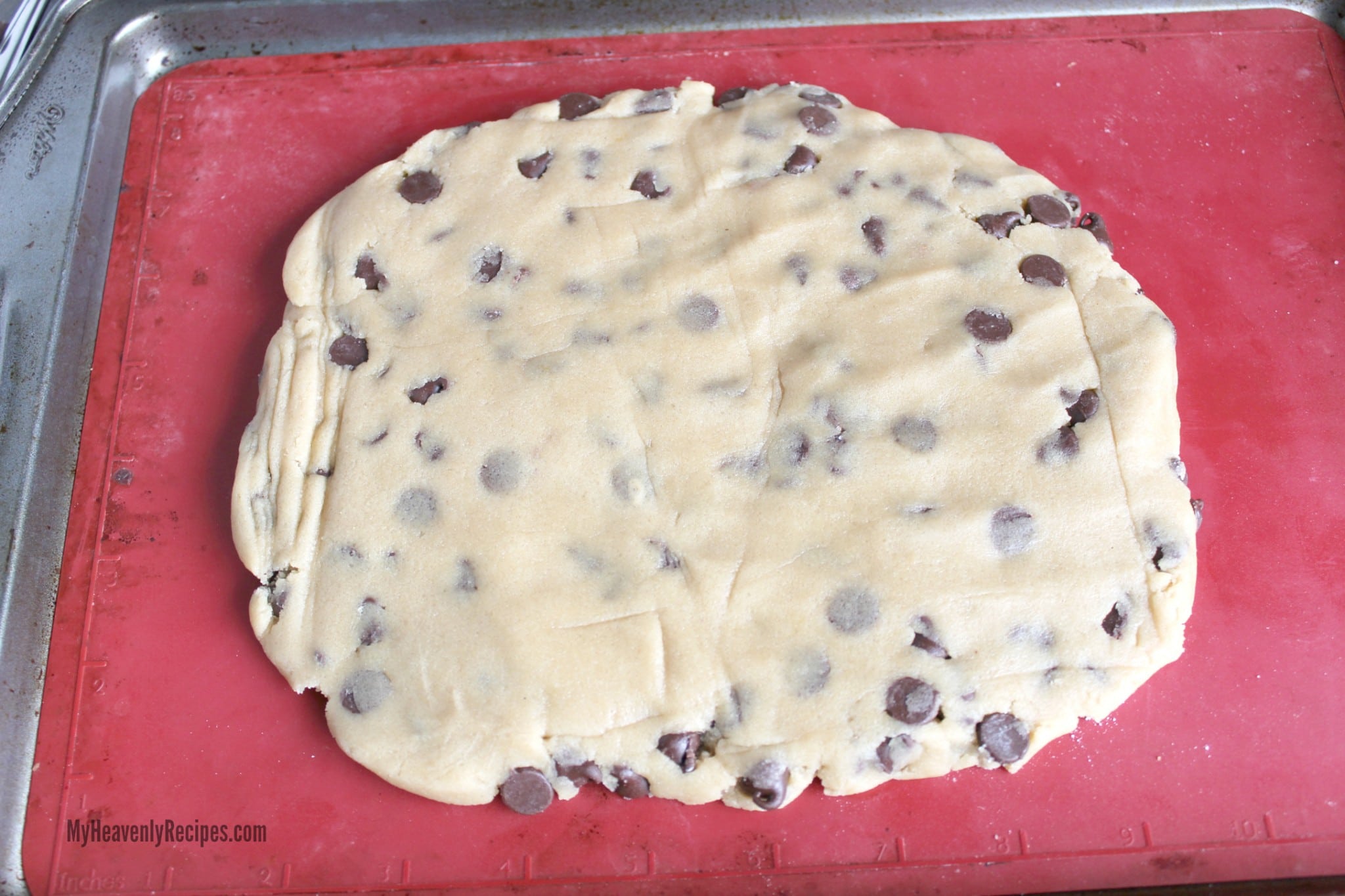 Chocolate Chip Cookie Dough Rolled Out on a baking sheet