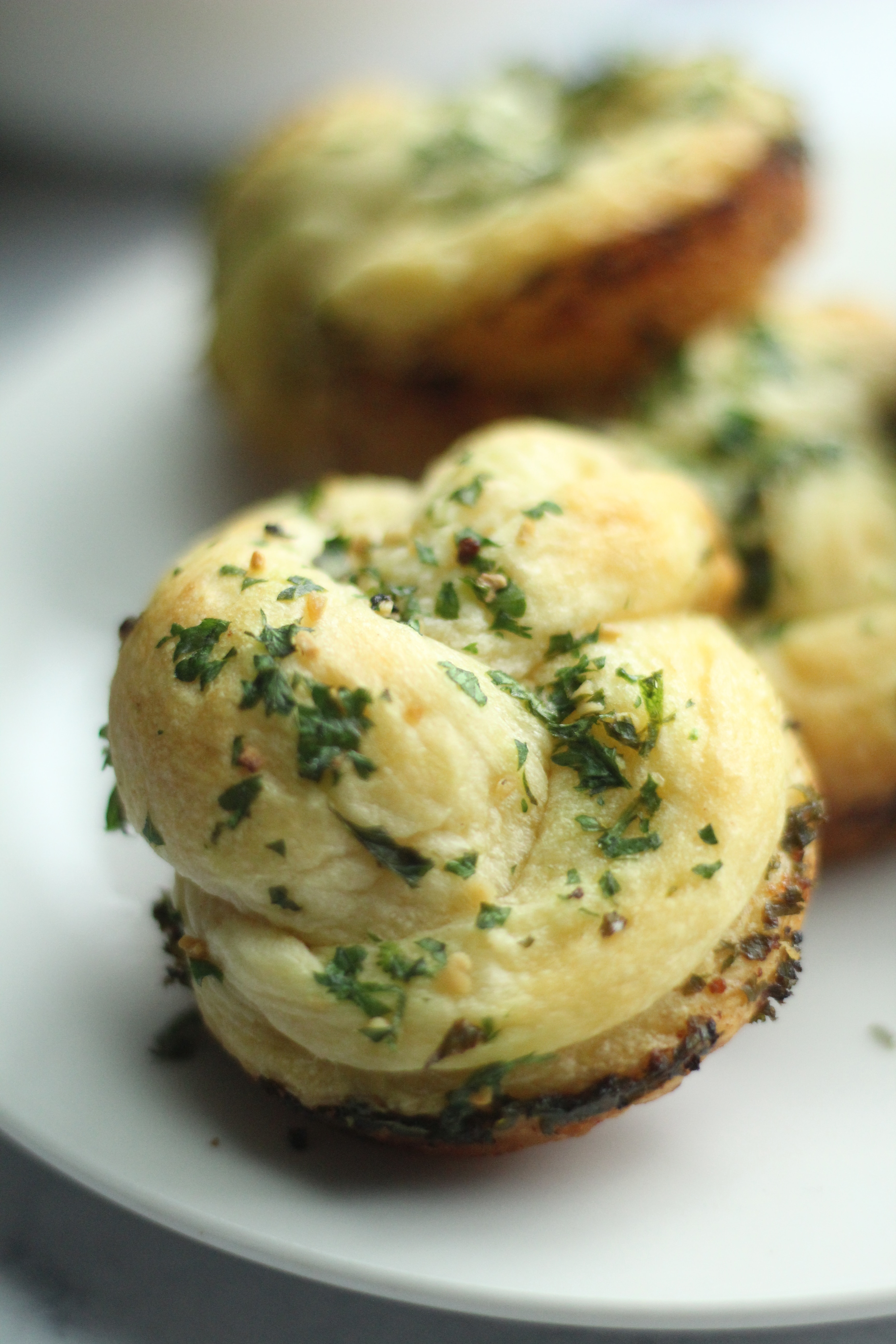 close up of garlic knots on plate