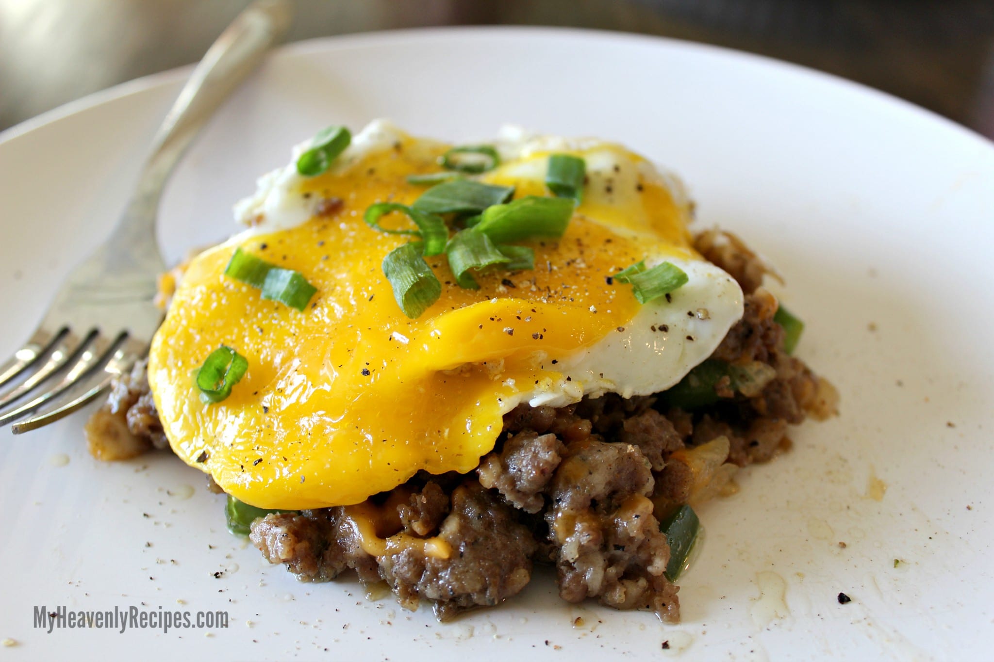 fried egg and sausage hash garnished with sliced green onions