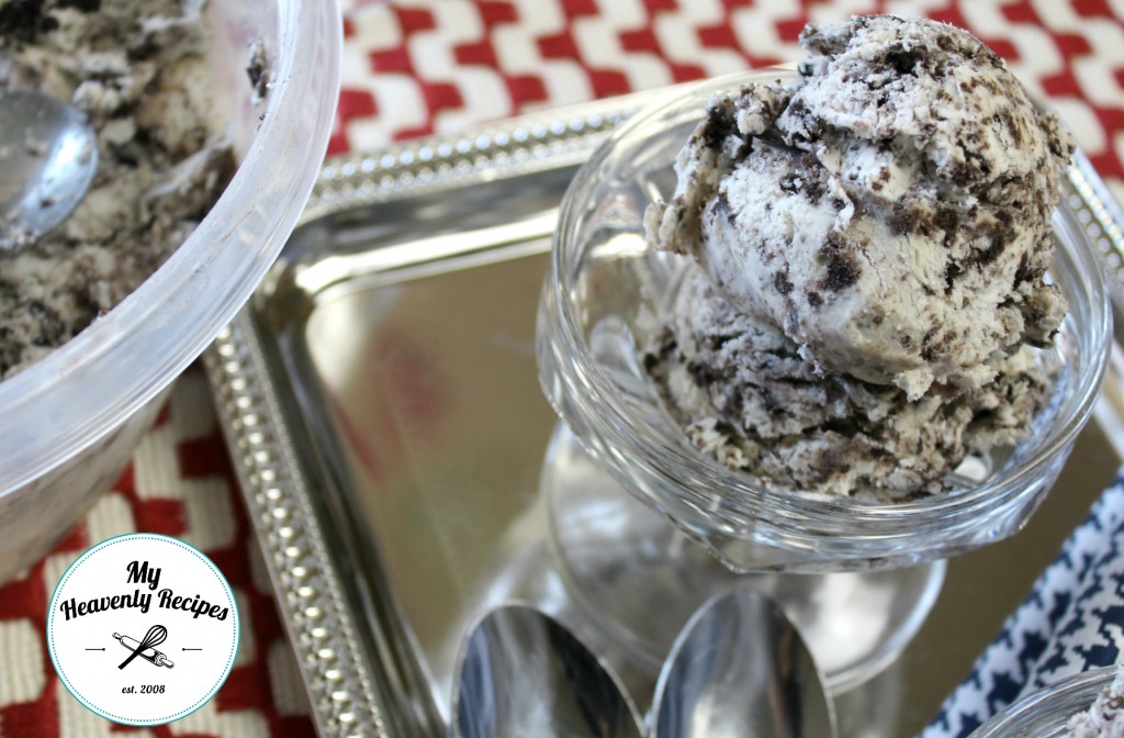 cookies and cream ice cream plated in a ice cream dish and spoons with red and white checkered place mat