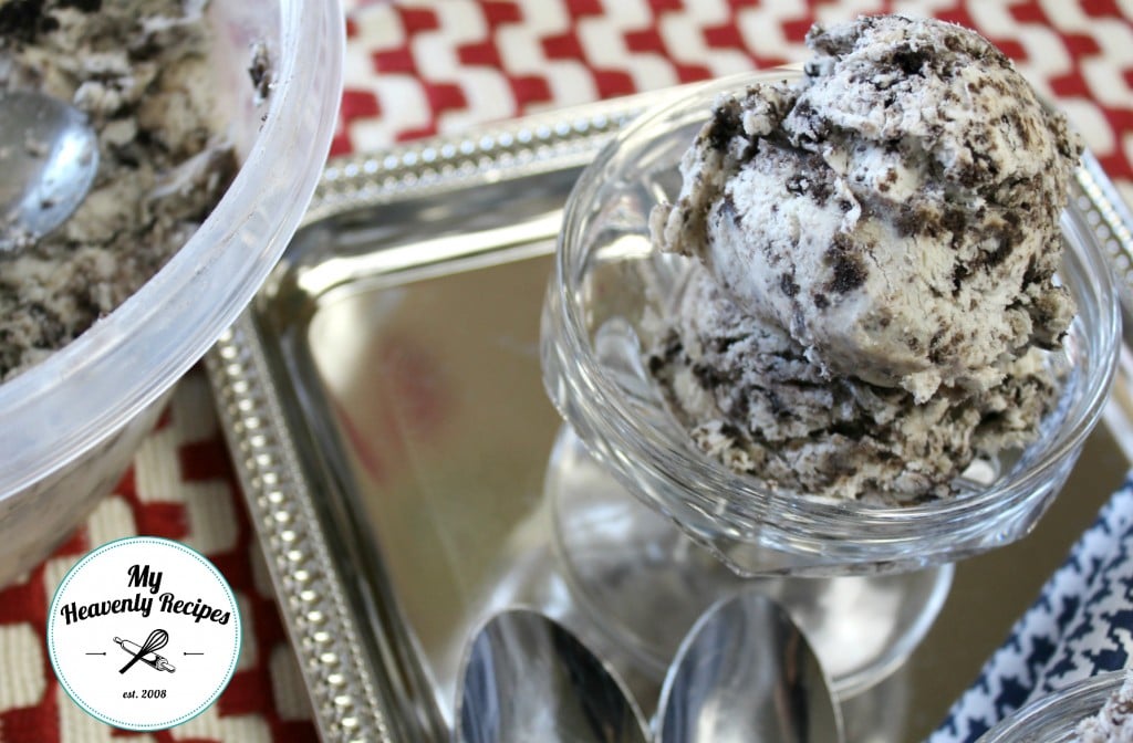 cookies and cream ice cream plated in a ice cream dish and spoons with red and white checkered place mat