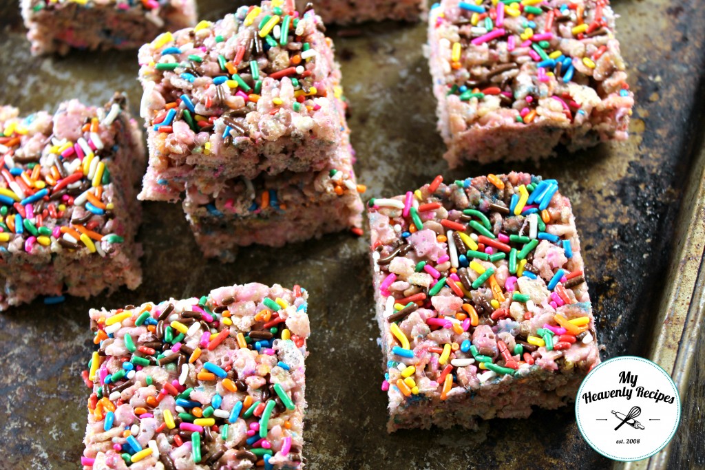 rainbow rice krispies treats with funfetti sprinkles on a baking sheet