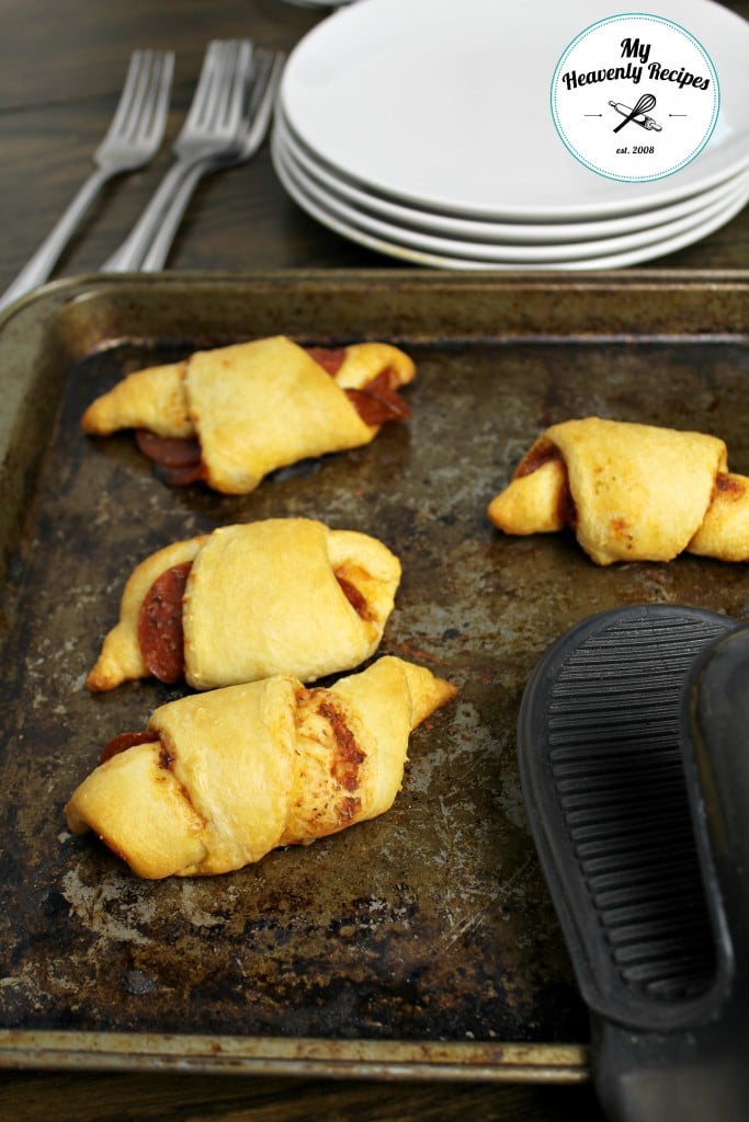 Pepperoni stuffed crescent rolls on a baking sheet