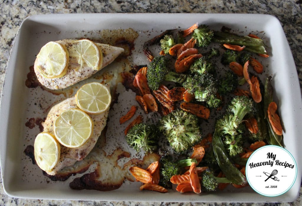 lemon chicken and vegetables on a large bar pan
