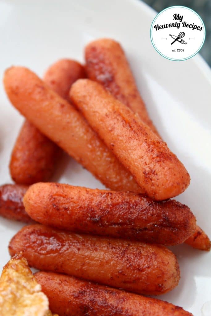 cinnamon glazed baby carrots on a white plate