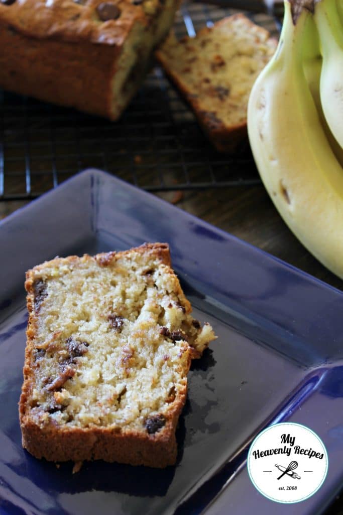 slice of banana bread on blue plate and sliced banana bread in background