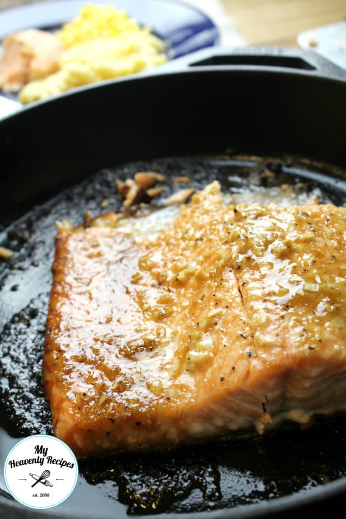 honey garlic salmon cooking in a skillet