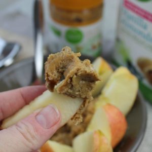 healthy peanut butter dip on apple slices (made with vanilla Shakeology)