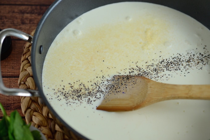 In the same skillet, heat water, heavy cream, garlic powder, Italian seasoning, and cheese until sauce become thick.