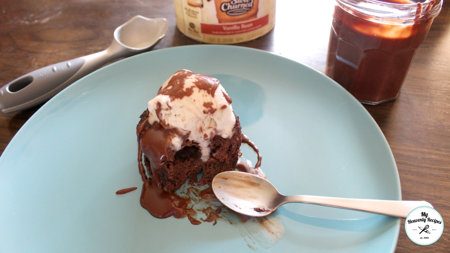 Chocolate Mug Cake topped with vanilla ice cream and chocolate sauce