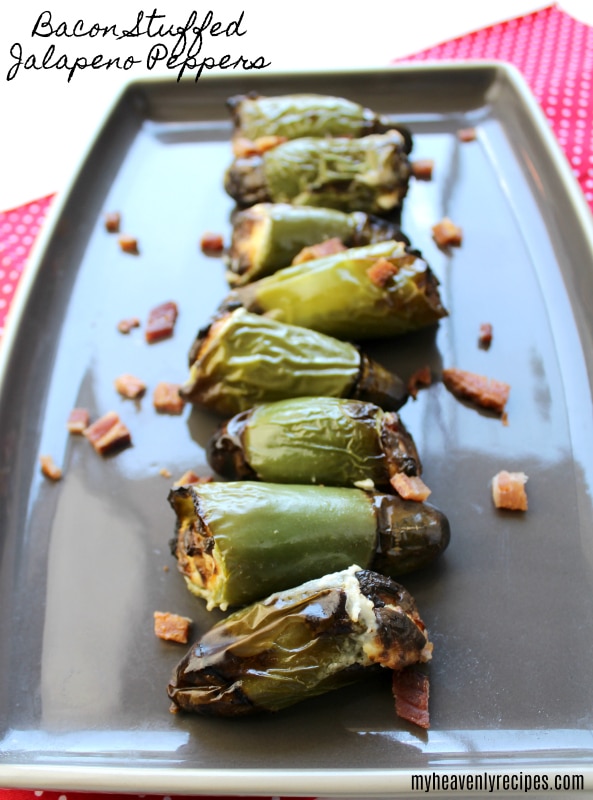 bacon and cream cheese stuffed jalapeno peppers on a serving platter