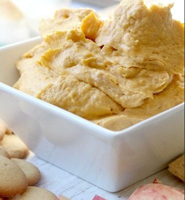 pumpkin dip recipe served in white bowl with apples and vanilla wafers