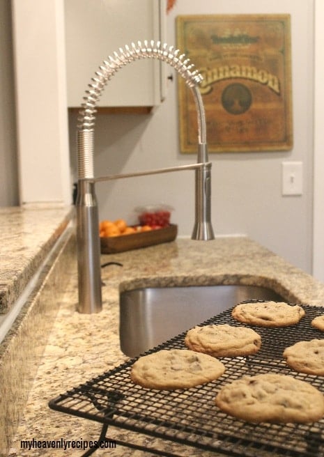 Grohe K7 kitchen faucet next to a cooling rack of bakery style chewy chocolate chip cookies