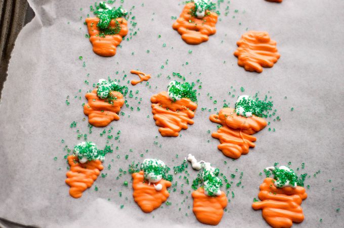 candy melts for easter cupcakes in the shape of carrots on wax paper