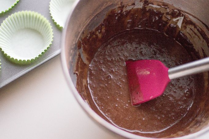 bowl of chocolate batter for easter cupcakes with pink spatula inside