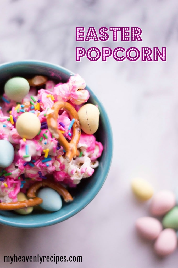 little blue bowl of Easter popcorn topped with pretzels and candies