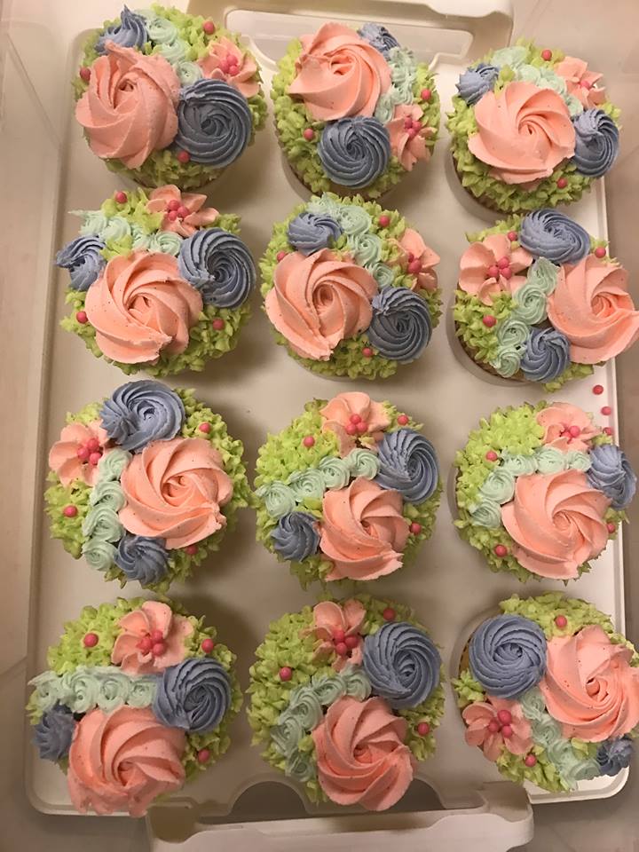 overhead view of 12 unicorn bouquet cupcakes in a cake tray