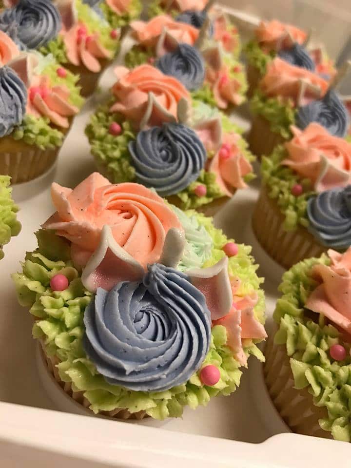 rows of unicorn bouquet cupcakes in a box