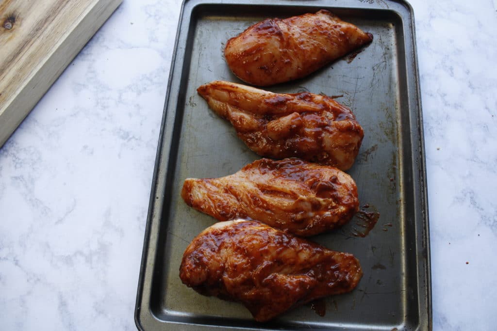 Alice springs chicken recipe on a baking sheet