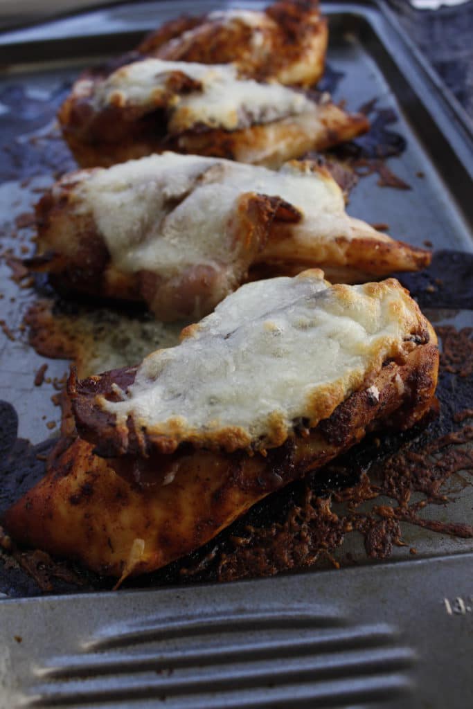 Alice springs chicken with cheese on a baking sheet