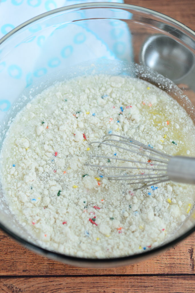 bowl with funfetti cake mix and whisk