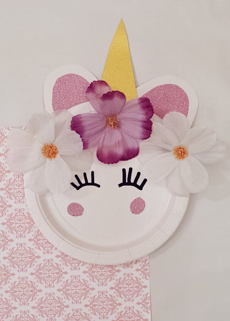 unicorn craft plate fully complete on top of pink and white towel