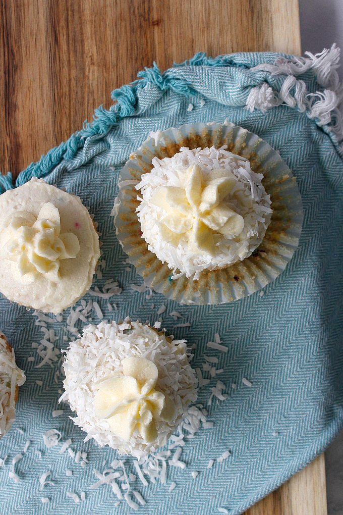 overhead view of three easter cupcakes on a blue towel