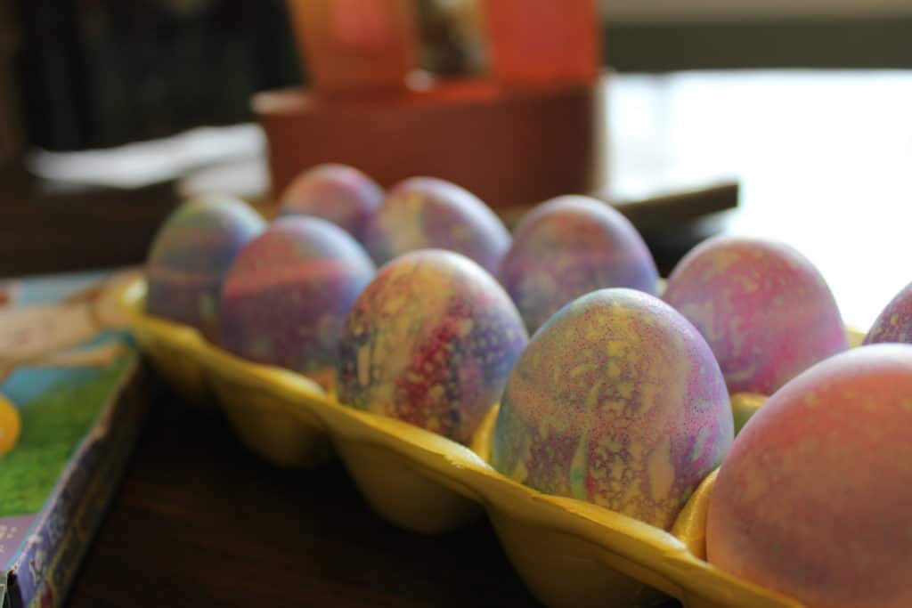 shaving cream decorated Easter eggs in egg carton