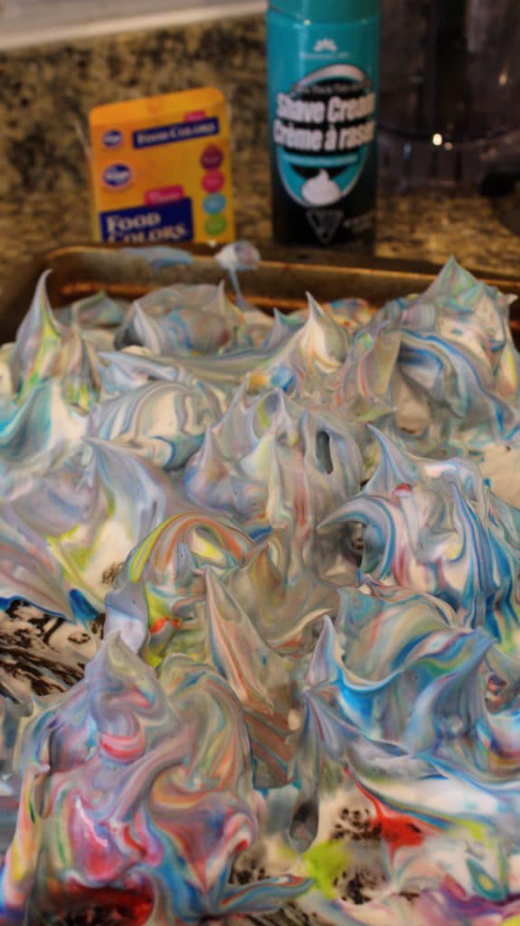 shaving cream mixture on baking sheet with food coloring