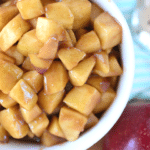 Easy homemade cinnamon apples close up in bowl vertical image