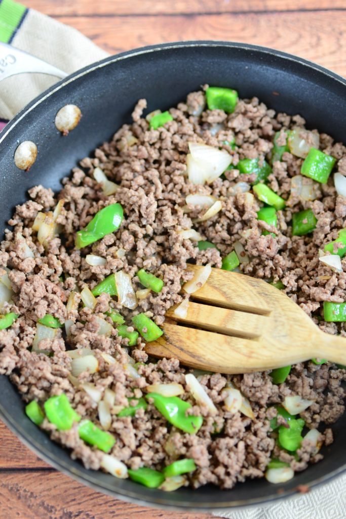 overhead shot of hamburger with green pepper and onions in skillet