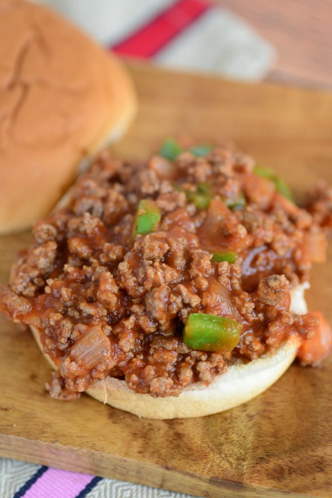 manwich sloppy joe on cutting board with top bun off