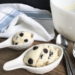 keto edible chocolate chip cookie dough in a small white spoon on cutting board