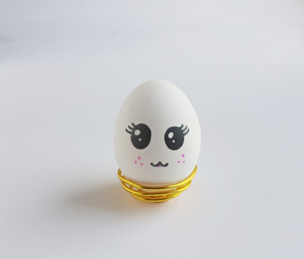 unicorn egg without horn sitting in gold egg holder