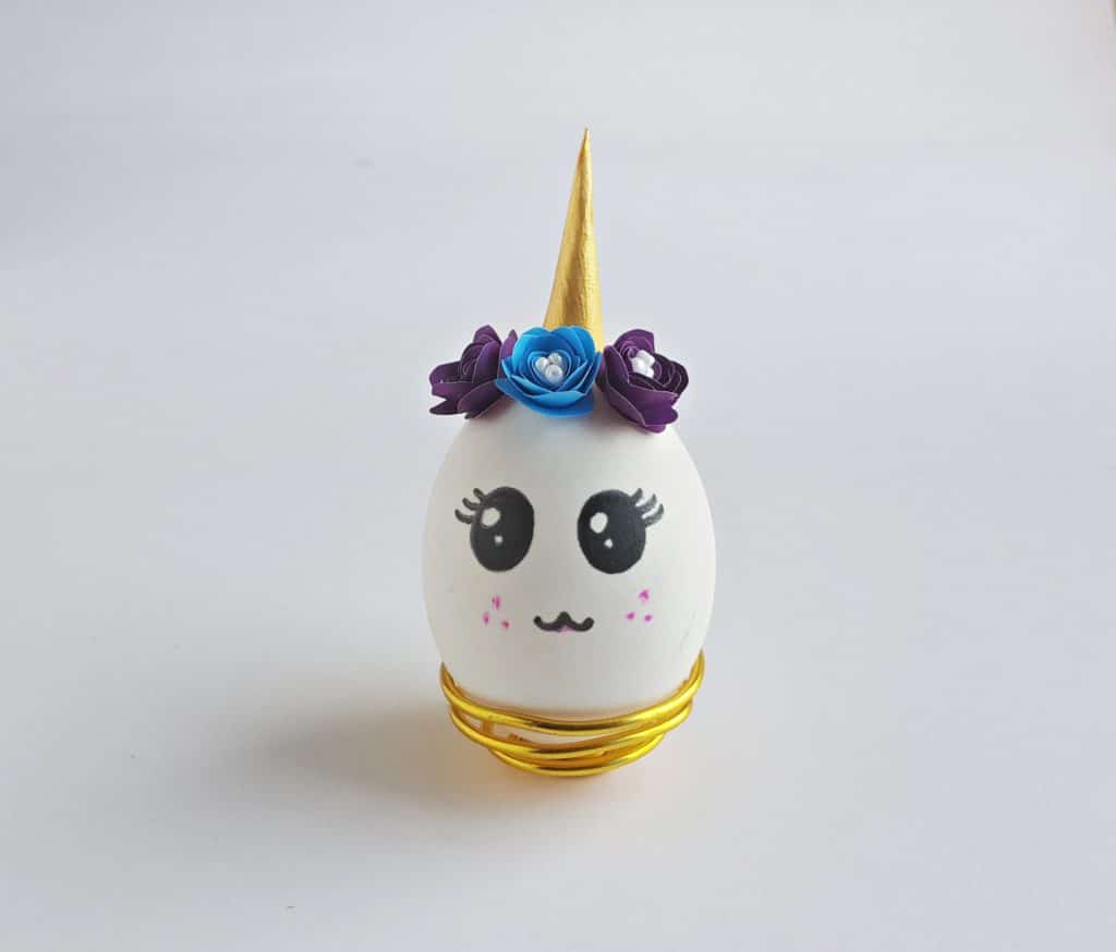 unicorn egg with crown of purple and blue flowers and gold horn